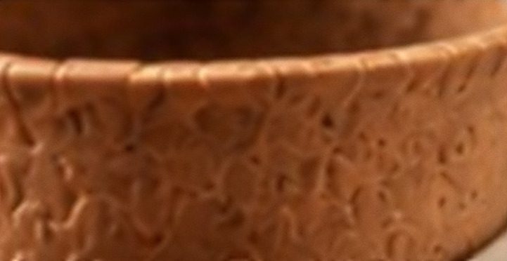 Macro view of the baked, textured surface of the edible cup.