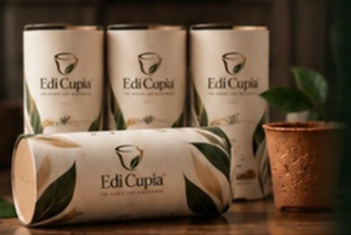 Edi Cupia paper tubes — the retail packaging for six edible cups — beside an unsleeved cup.